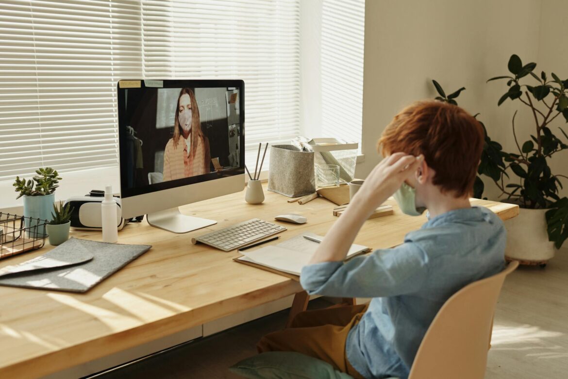 photo of boy watching through imac