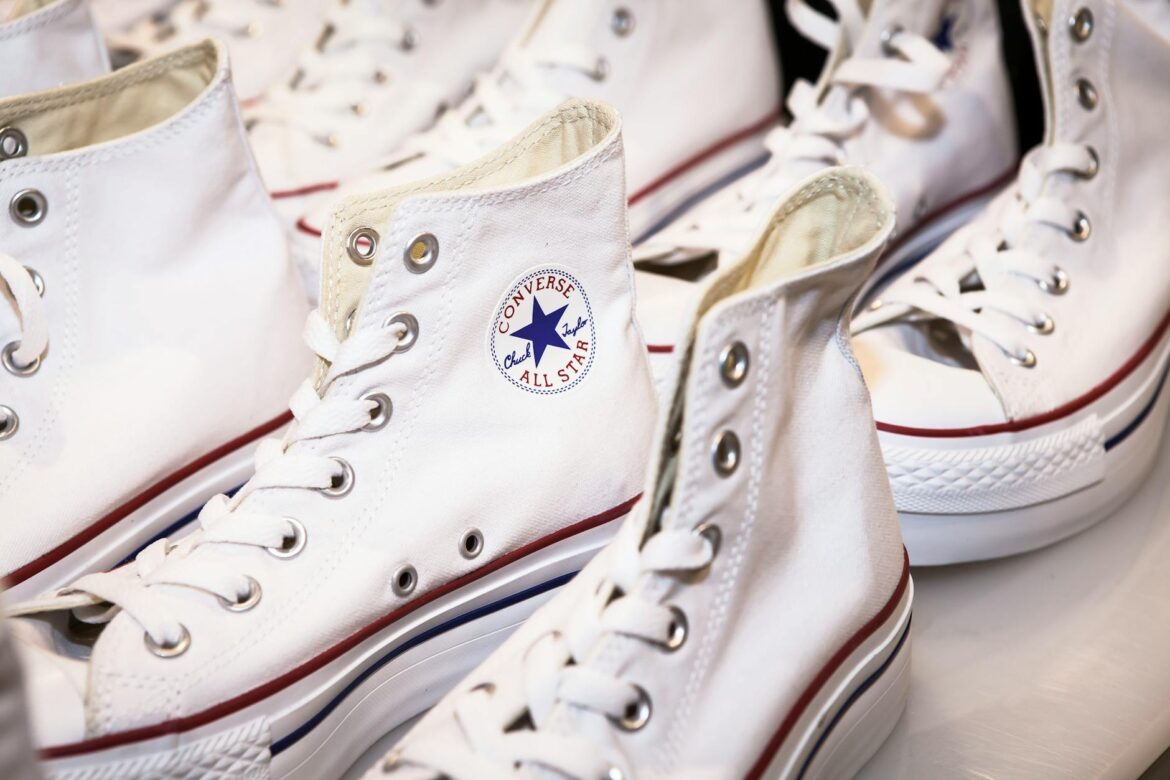 two pairs of white and red converse all star shoes